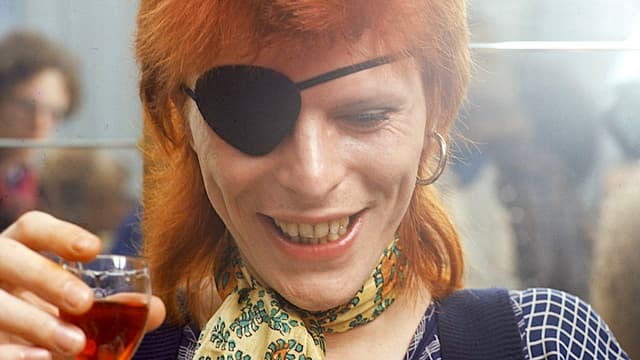 "Once we realised the guys with guns pointed to our heads were cops, we were relieved." The night that armed police gatecrashed David Bowie's end-of-tour party