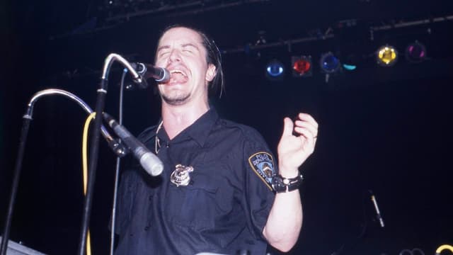 "When Mike was apprehended back stage and pulled the dildo from his pants, the tension was relieved." The night a pissed-off Mike Patton pissed on concert security staff, and avoided arrest by pretending it was all a hilarious prank