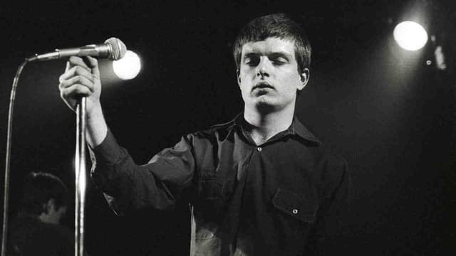 “We would just have done it balls out, legs akimbo like Status Quo. and probably messed it up”: The classic song that gave an iconic post-punk band their biggest hit – and became an epitaph for their tragic singer